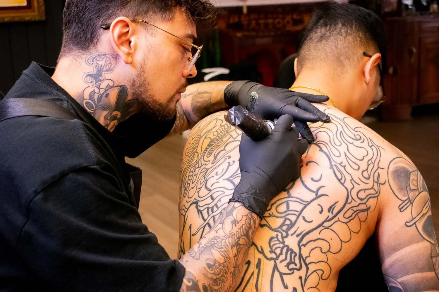 Dylan Prorok tattooing a large-scale Japanese piece